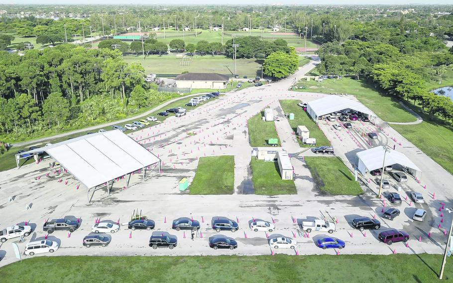 Aerial view shows cars lining up at Tropical Park's COVID-19 testing site in Miami, Florida on Friday, July 30, 2021. 