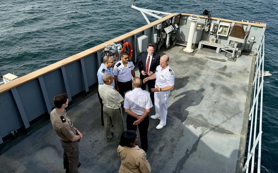 The Commanding officer of the USS Whitney with Military and civilian officals.