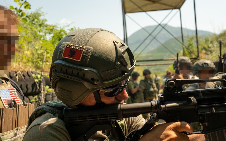 A U.S. Army Green Beret observes close-quarter battle drills conducted by the Albanian special forces July 21, 2021. 