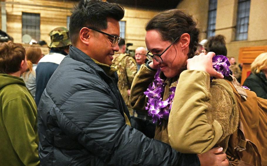 1st Lt. Arnold Estrada gives his girlfriend, 1st Lt. Kaylee McGlasson, a lei at a welcome home ceremony for the 3rd Battalion, 197th Field Artillery Regiment on Feb. 8, 2024, at the Manchester, N.H., armory. Estrada transferred from the Hawaii National Guard 