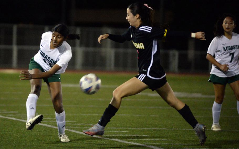 Kubasaki's Solares Solano boots the ball past Kadena's Yume Catlett during Wednesday's DODEA-Okinawa girls soccer match. The teams played to a 1-1 draw.