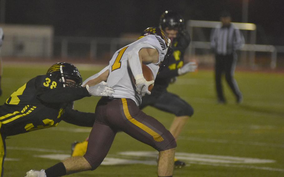 Stuttgart's Christian Just grabs whatever he can hold onto to try to stop Vilseck's Nicolas Holcomb from advancing with the ball in the DODEA-Europe Division I championship game at Kaiserslautern, Germany, on Oct. 30, 2021.