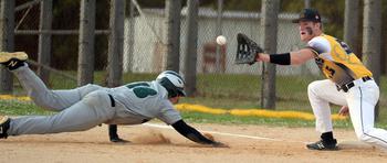 Kadena's Austin Gagnon awaits the attempted pickoff throw as Kubasaki's Micah Thibert dives back to first base during Monday's DODEA-Okinawa baseball game. The Dragons won 8-3.