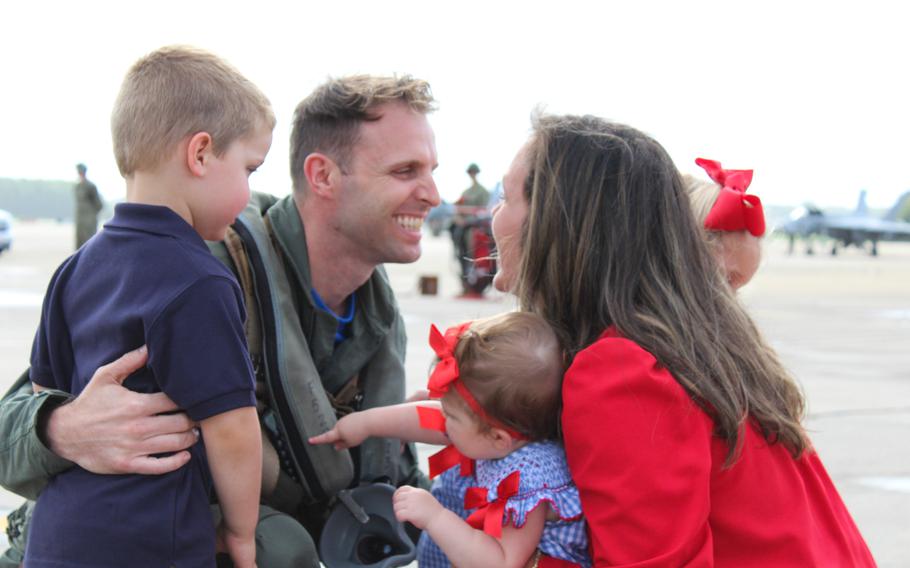 Lt. Mike Buck is greeted by his wife, Kristina, and children, 3-year-old twins Luke and Emma and 9-month-old Sofia. 
