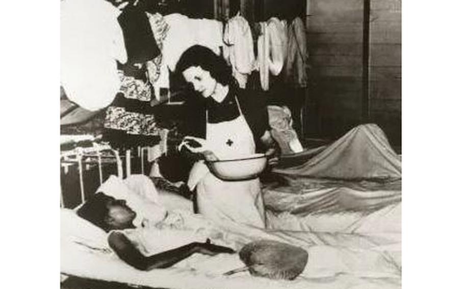 Lt. Margaret ‘Peggy’ Nash administers care to a fellow prisoner in the Santo Tomas camp hospital, circa 1943.