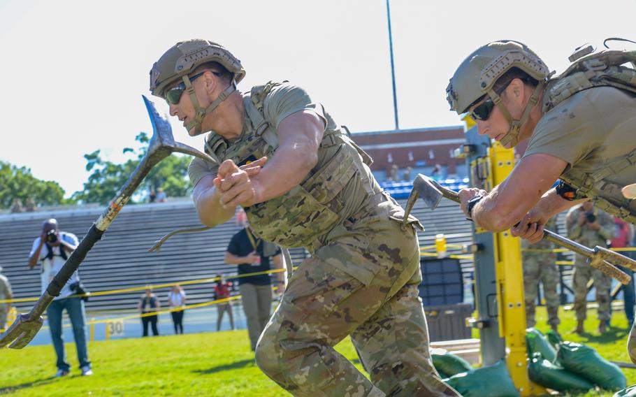 Best Ranger competitors drop crowbars after breaching a door obstacle during the second day of the Army’s annual Best Ranger Competition on Saturday, April 13, 2024, at A.J. McClung Stadium in downtown Columbus, Ga. 