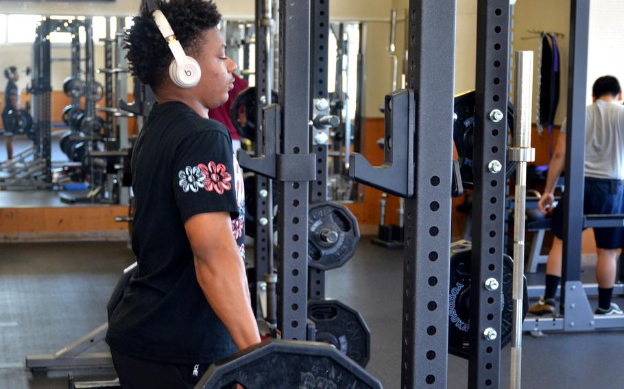 Navy airman James Browder of the aircraft carrier USS Ronald Reagan works out in the Fleet Recreation Gym at Yokosuka Naval Base, Japan, March 13, 2024. 