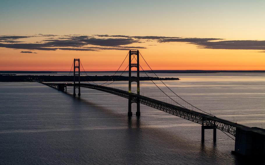 The sun rises near the Mackinac Bridge