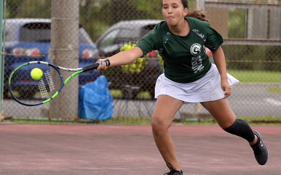 Kubasaki's Ella Perez lunges to hit a forehand against Kadena's Christine Ryan during the Okinawa district tennis finals. The match was scheduled for Tuesday, but only four minutes were played before rain fell and the match was pushed to Thursday. Perez dethroned last year's island champion Ryan 9-8 (7-3).