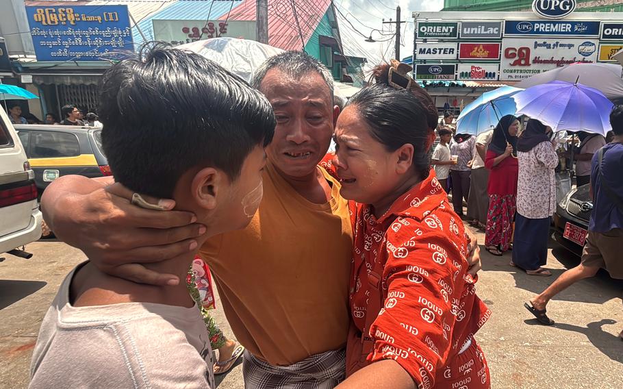 A man hugs his familky.