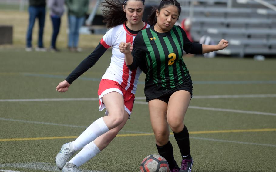 Nile C. Kinnick's Julia Angelinas and Robert D. Edgren's Sharisse Reyes scuffle for the ball during Saturday's DODEA-Japan girls soccer match. The Red Devils shut out the Eagles 5-0.