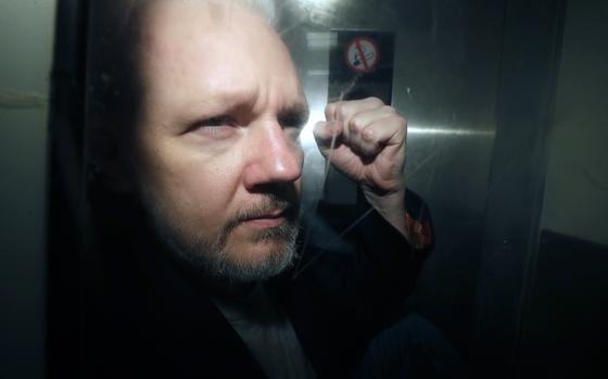 FILE - WikiLeaks founder Julian Assange being taken from court, where he appeared on charges of jumping British bail seven years ago, in London, Wednesday May 1, 2019. Assange faces what could be his final court hearing in England over whether he should be extradited to the United States to face spying charges. (AP Photo/Matt Dunham, File)