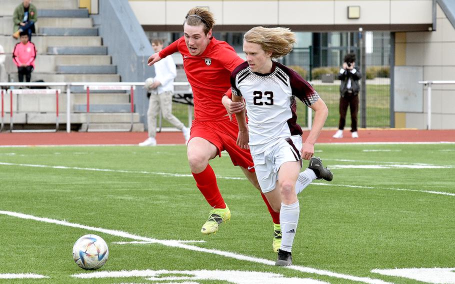 Vilseck's Stokley Fudge, right, dribbles as Kaiserslautern's Brandon Patterson, left, jostles during the first half of Saturday's match at Kaiserslautern High School in Kaiserslautern, Germany. The Falcons won, 5-4.