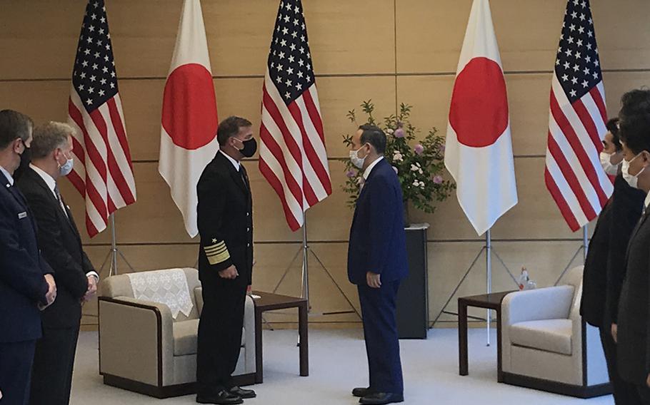 Adm. John Aquilino greets Japanese Prime Minister Yoshihide Suga during his first trip to Tokyo since taking the helm of U.S. Indo-Pacific Command, Tuesday, June 1, 2021. 