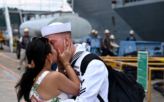 A sailor kisses his partner during a first-kiss ceremony.