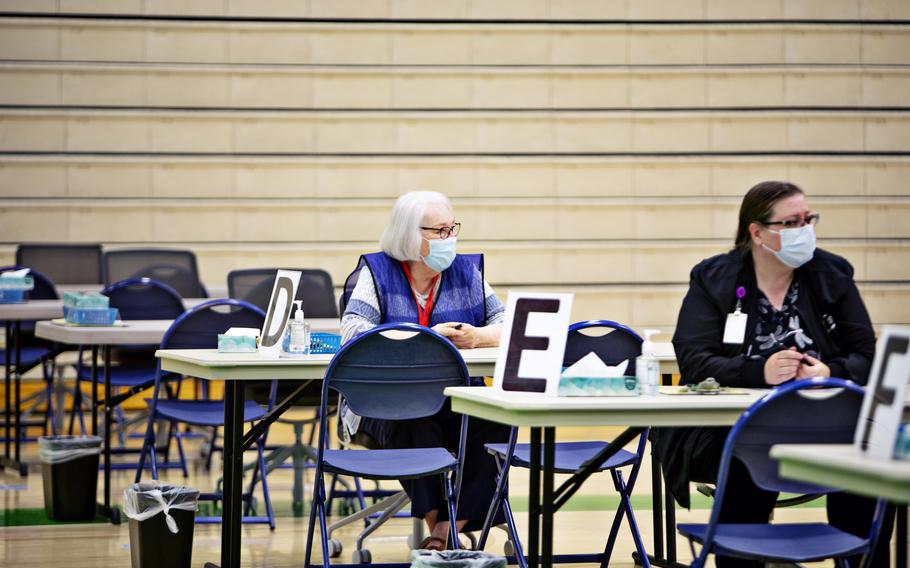 Health workers wait for people seeking shots at a vaccination clinic in Provo, Utah, on June 2. 