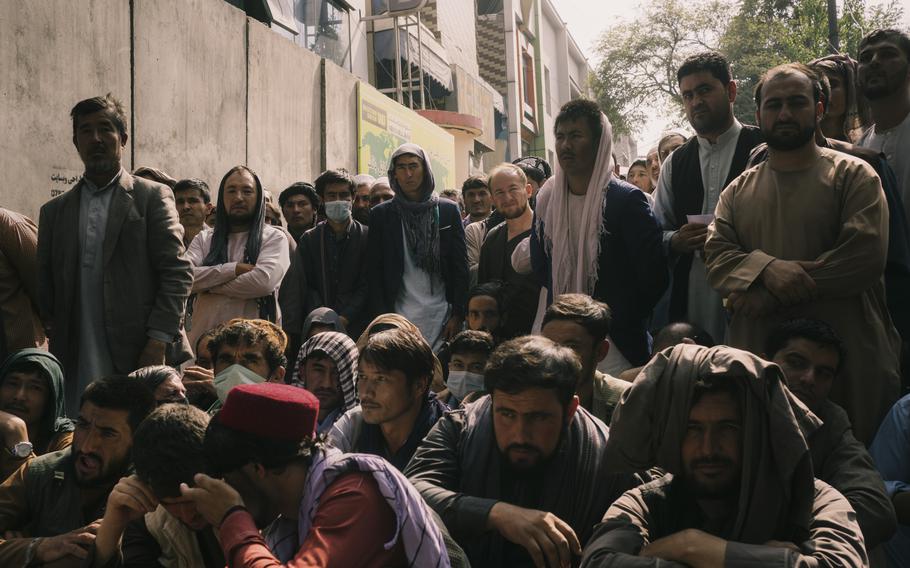 Holders of bank accounts wait in front of a Kabul bank on Sept. 29, 2021.