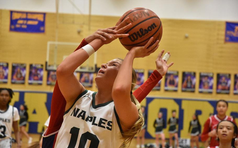 Naples’ Gracie Grannis didn’t get a foul called while driving for a layup. But her team defeated Aviano on the opening day of the DODEA European Basketball Division II Championships on Wednesday, Feb. 14, 2024 in Wiesbaden, Germany.