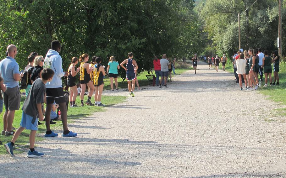 Onlookers cheer on Andrew McGovern, a Vicenza junior, who placed second in the boys' cross country run that also featured teams from Aviano, Naples and Sigonella.