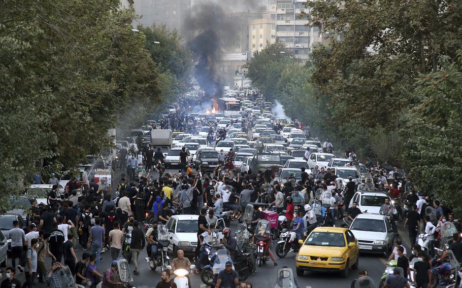 In this Wednesday, Sept. 21, 2022, photo taken by an individual not employed by the Associated Press and obtained by the AP outside Iran, protesters chant slogans during a protest over the death of a woman who was detained by the morality police, in downtown Tehran, Iran. Iranians saw their access to Instagram, one of the few Western social media platforms still available in the country, disrupted on Wednesday following days of the mass protests.