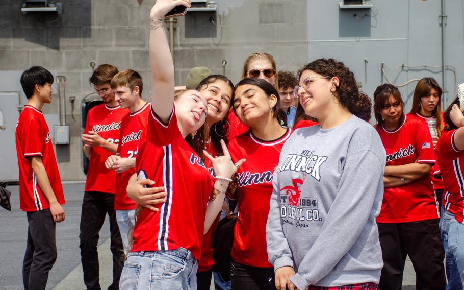 Seniors from Nile C. Kinnick High School take a selfie aboard the aircraft carrier USS Ronald Reagan at Yokosuka Naval Base, Japan, April 18, 2023.