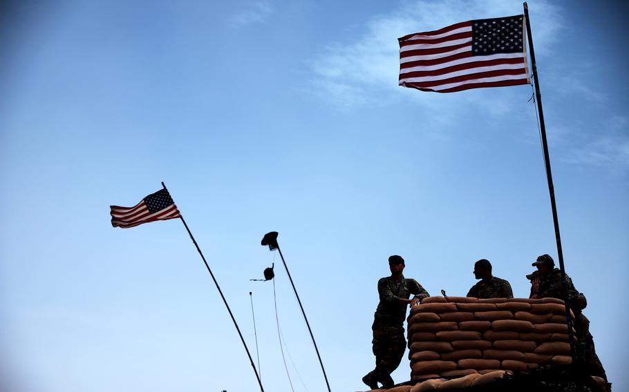 Soldiers deployed to al-Tanf garrison in Syria watch for the impact of a mortar round from an observation point during a readiness exercise on April 22, 2020. 