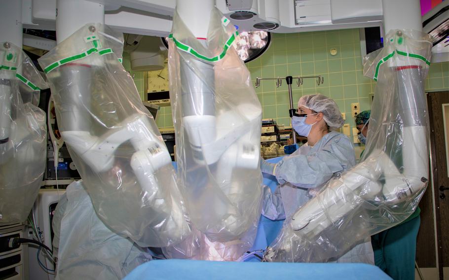 A staff member positions a robotic surgical system during an operation at Landstuhl Regional Medical Center, Germany, Jan. 12, 2022. The medical center recently increased access to care for surgical services to non-active duty patients.
