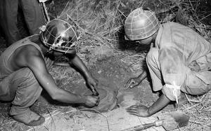 U.S. soldiers plant an anti-tank land mine somewhere on the Korean Peninsula, July 22, 1950. 