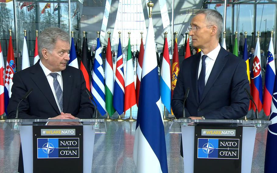 Finnish President Sauli Niinisto, left, and NATO Secretary-General Jens Stoltenberg talk to reporters before the raising of the Finnish flag at NATO headquarters in Brussels, April 4, 2023. Finland became the 31st member of the alliance.