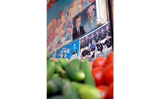 (enw# 43p rb) enw30KHANIQIN2

KHANIQIN, IRAQ

23 JULY 08

By James Warden/Stars and Stripes



A photo of Iraqi President Jalal Talabani and Kurdistan Regional Government President Masoud Barzani hangs next to advertisements and posters of famous soccer teams Wednesday at a vegetable store in Khaniqin, Iraq. Photos of the two Kurdish leaders are plastered across the area’s shops and government buildings, while the faces of Arab leaders like Prime Minister Nouri al-Maliki are entirely absent.

