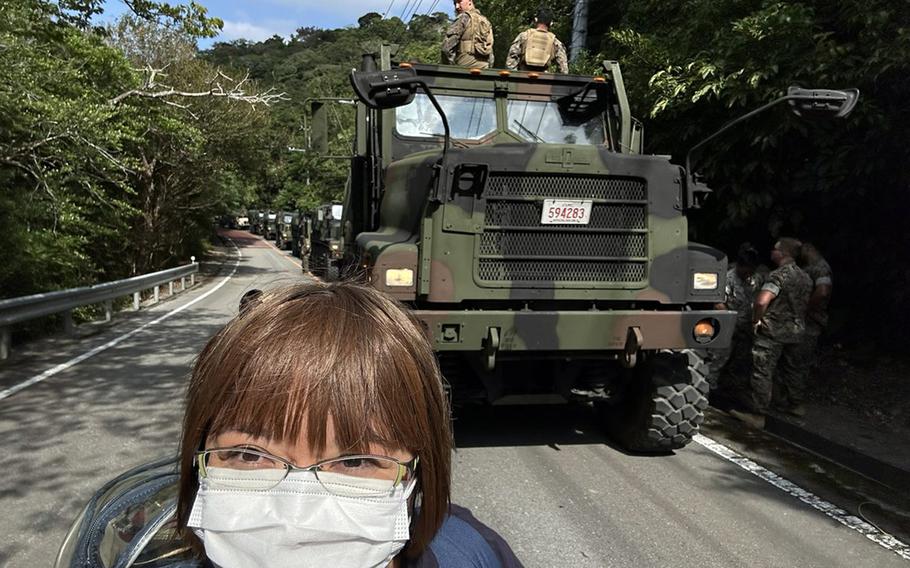 Akino Miyagi poses with U.S. military vehicles in northern Okinawa in this undated photo posted to X, formerly known as Twitter. 