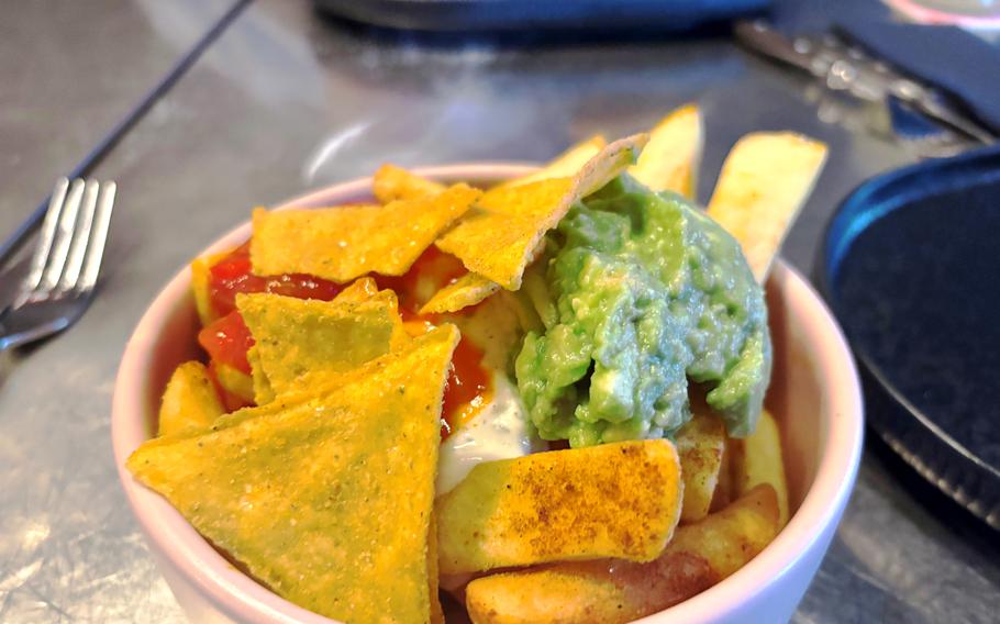 Fries topped with salsa, sour cream and guacamole.