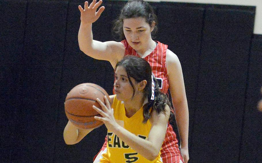Robert D. Edgren's I'Lei Washington looks to pass in front of Nile C. Kinnick's Maria Pidgeon during Friday's semifinal in the DODEA-Japan girls basketeball tournament. The Red Devils won 53-10 and will face E.J. King in Saturday's final.