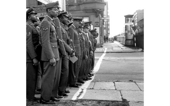 Berlin, October, 1961: American airmen from the RAF Wethersfield football team, sightseeing while in town for a game against the Berlin Bears, toe a line marking the border between East and West as they view the Berlin Wall from the Friedrichstrasse.

Looking for Stars and Stripes’ historic coverage? Subscribe to Stars and Stripes’ historic newspaper archive! We have digitized our 1948-1999 European and Pacific editions, as well as several of our WWII editions and made them available online through https://starsandstripes.newspaperarchive.com/

META TAGS: Germany; post-war; African American; Cold War; 