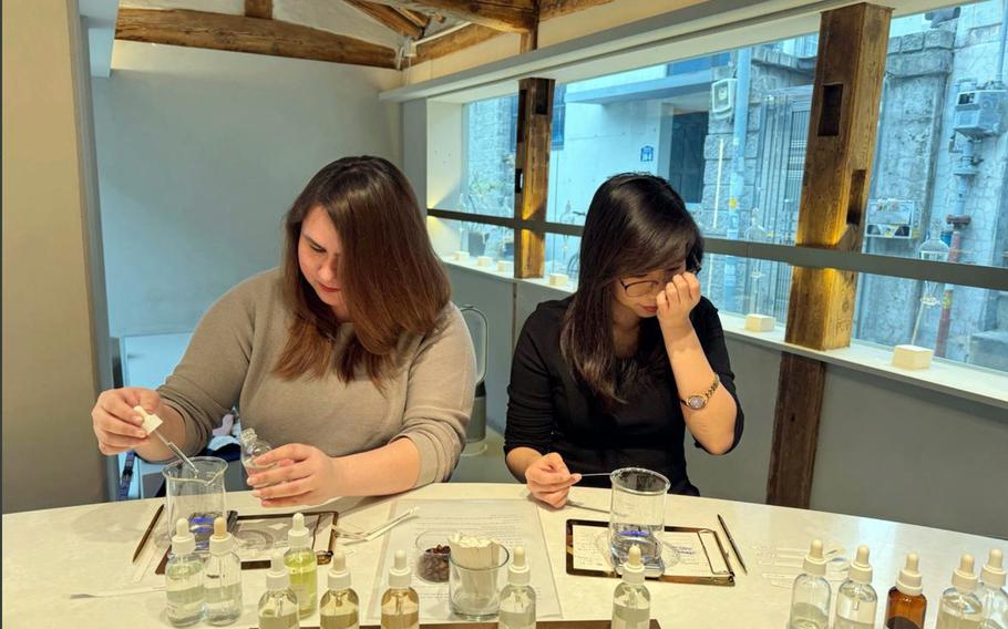 Guests create personalized fragrances during a perfume-making class at Proust Scent in Seoul, South Korea, July 1, 2025. 