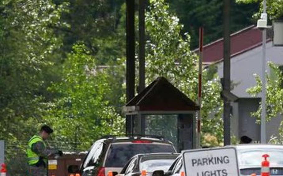 Military police check identifications at an entry gate of Joint Base Lewis-McChord in Washington.