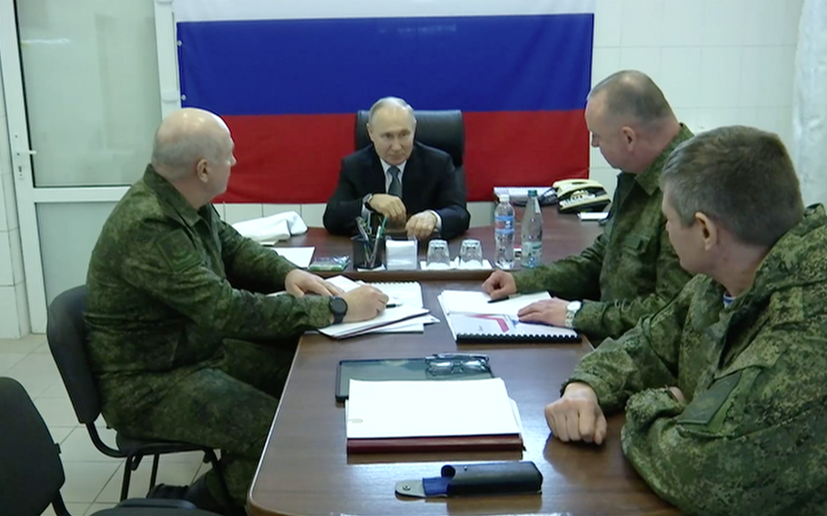 Russian President Vladimir Putin, center, visits Russian forces in the Kherson sector. U.S. intelligence holds that Russia will be able to fund the war in Ukraine for at least another year, even under the heavy and increasing weight of unprecedented sanctions, according to leaked U.S. military documents.