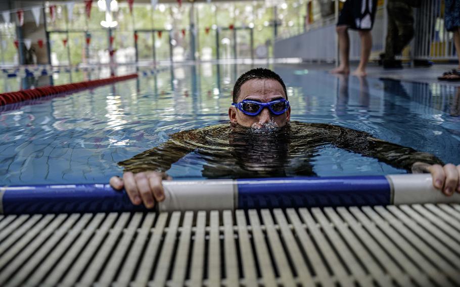 Air Force Staff Sgt. Steven Hermosisima, a unit deployment manager with the 721st Air Mobility Operations Group, takes a final breath before pushing off to start the swim portion of the German Armed Forces Badge for Military Proficiency at Ramstein Air Base, Germany, April 22, 2024.