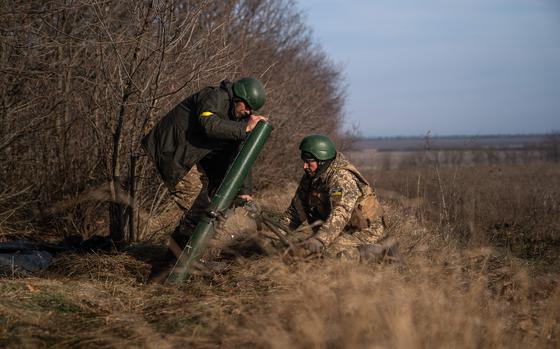 Ukrainian soldiers fire a mortar launcher at a position along the front line in Donetsk region on Dec. 9, 2022, amid the Russian invasion of Ukraine. (Ihor Tkachov/AFP/Getty Images/TNS)