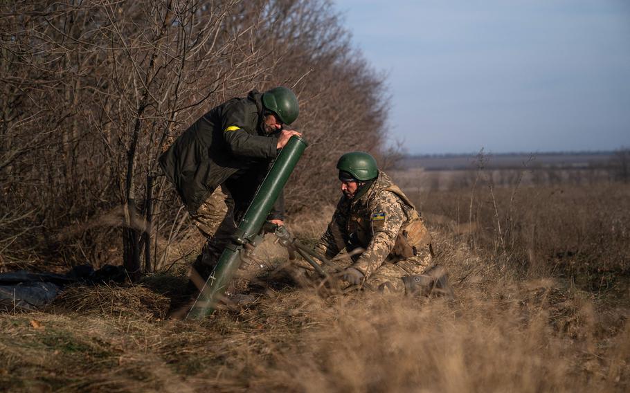 Ukrainian soldiers fire a mortar launcher at a position along the front line in Donetsk region on Dec. 9, 2022, amid the Russian invasion of Ukraine.