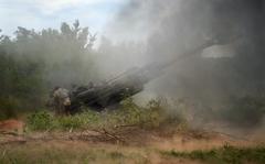 FILE - Ukrainian soldiers fire at Russian positions from a U.S.-supplied M777 howitzer in Ukraine's eastern Donetsk region on June 18, 2022. Even as Russian troops slowly press their offensive across Ukraine's east, trying to achieve the Kremlin's goal of securing full control over the country's industrial heartland, Ukrainian forces are scaling up attacks to reclaim territory in the Russian-occupied south. (AP Photo/Efrem Lukatsky, File)
