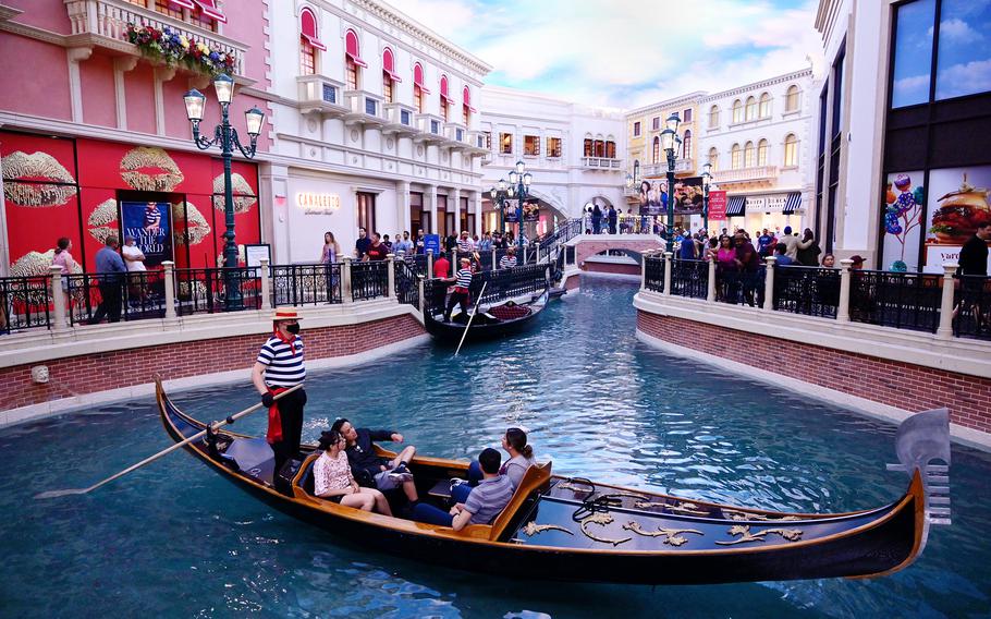 Tourists glide down the Grand Canal in a gondola at the Venetian Resort. 