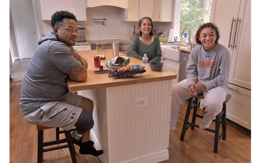Lexi Terry, a McDonogh varsity soccer player, relaxes on the weekend by watching football at home with her parents, Jae, left, and Kimberly. 