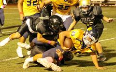 Guam High running back Terrell Rosario tries to squeeze out a couple more yards through the Tiyan defense.