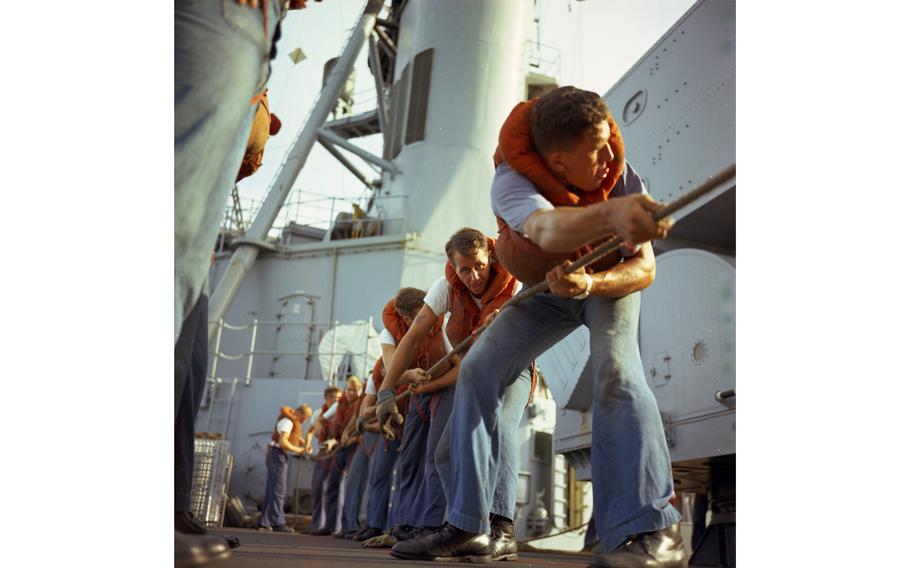 Sailors pull rope during the refueling and rearming operation on board the USS Buchanan destroyer by the tanker USS Tappahannock (not visible).