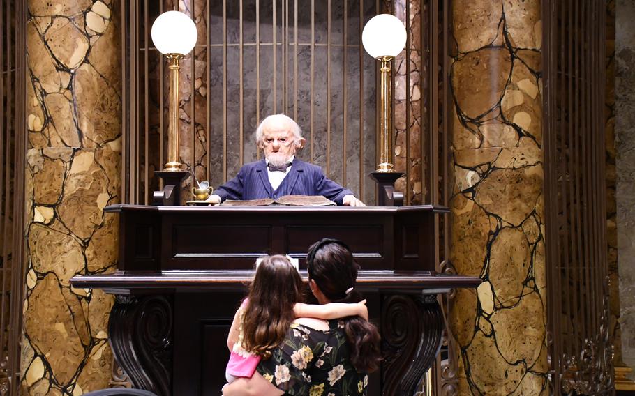 My wife and daughter admire a mannequin at the Harry Potter movie studio tour in England.