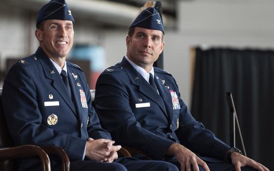 Col. David Epperson, the 52nd Fighter Wing's outgoing commander, left, and Col. Leslie Hauck, the incoming commander, listened to opening remarks from Maj. Gen. Randall Reed, 3rd Air Force commander, during the wing's change of command ceremony July 15, 2021, on Spangdahlem Air Base, Germany. The evening before the ceremony, the colonels were together in neighboring villages, filling sandbags to help stem flooding after days of heavy rainfall.