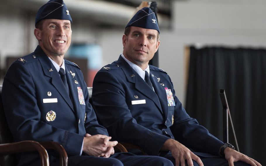 Col. David Epperson, left, the 52nd Fighter Wing's outgoing commander, and Col. Leslie Hauck, the incoming commander, listened to opening remarks from Maj. Gen. Randall Reed, 3rd Air Force commander, during the wing's change of command ceremony July 15, 2021, on Spangdahlem Air Base, Germany. 