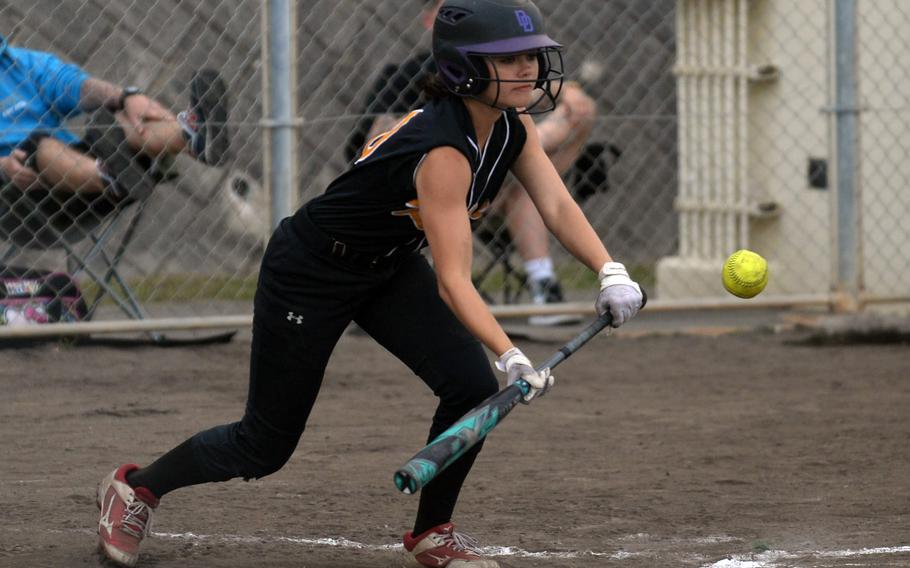 Kadena's Mylein Tull drops a safety squeeze bunt against Kubasaki during Tuesday's Okinawa softball game. The Panthers won 19-4 in a game that ended on Tull's opposite-field, walk-off, in-park grand slam in the bottom of the fifth inning.