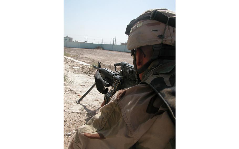 Spc. Alfredo Zendijias, a soldier from Company C, 4th Battalion, 31st Infantry Regiment holds his position while securing the site of a mysterious explosion at the Saba al Boor police station in Iraq the day before.